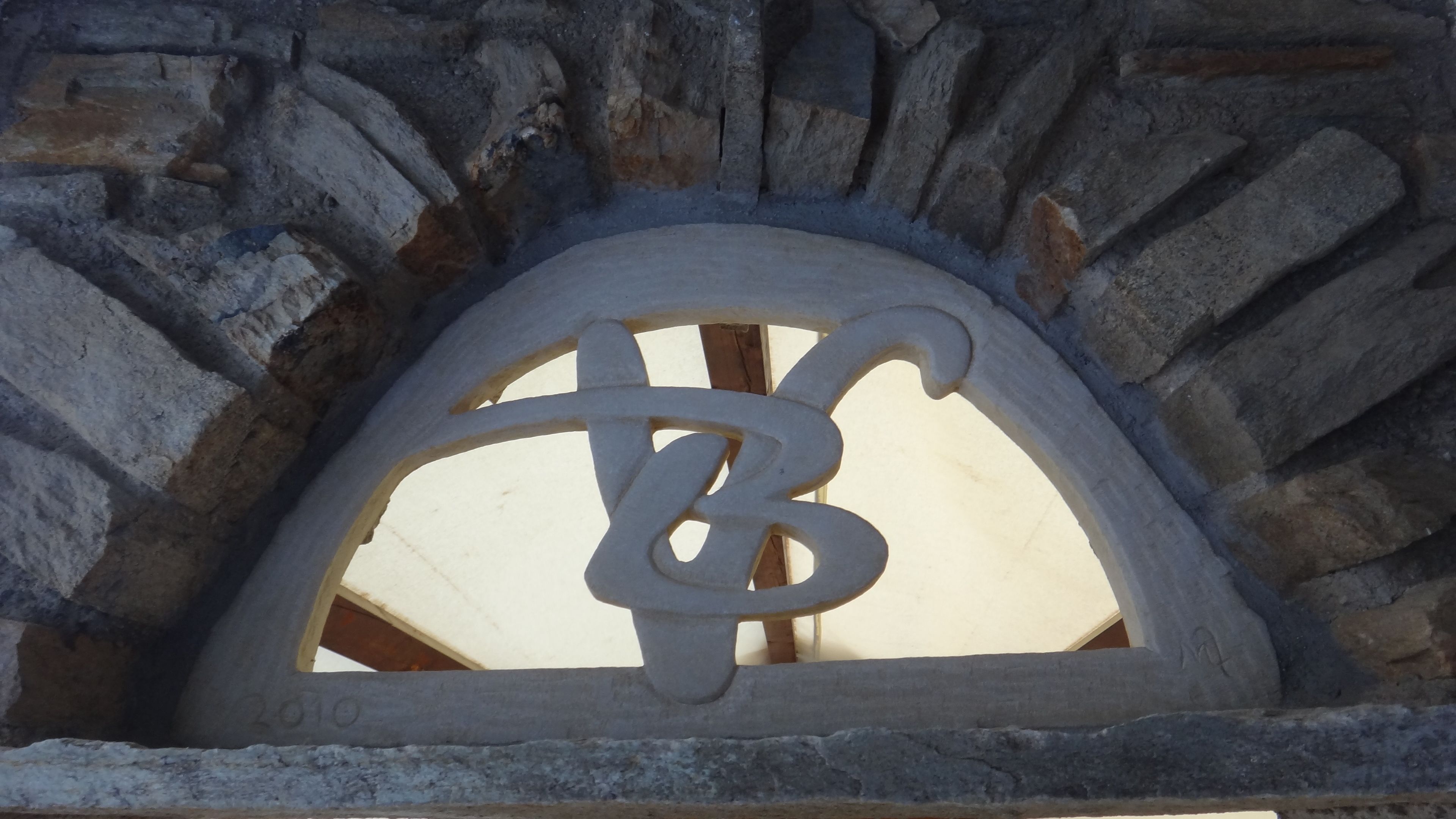 A stone archway with a carved letter 'B' and the number '010' visible.