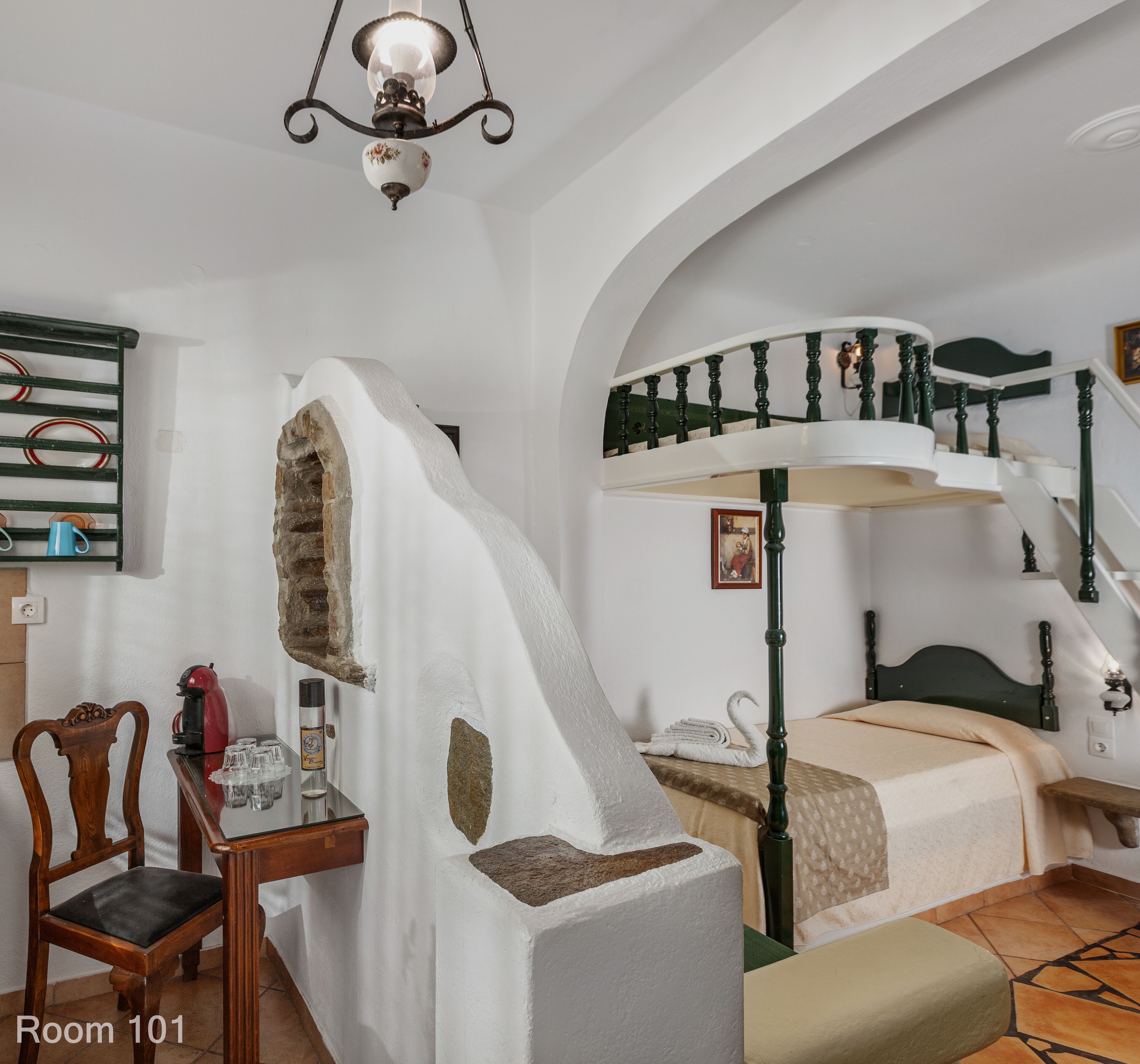 A room with a unique architectural design, including a sloped ceiling and a spiral staircase.