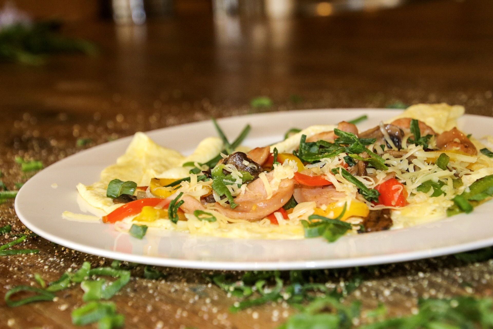 A plate of food with shrimp, vegetables, and cheese on a table.