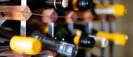 A wine rack with various bottles, some with corks and others with screw caps.