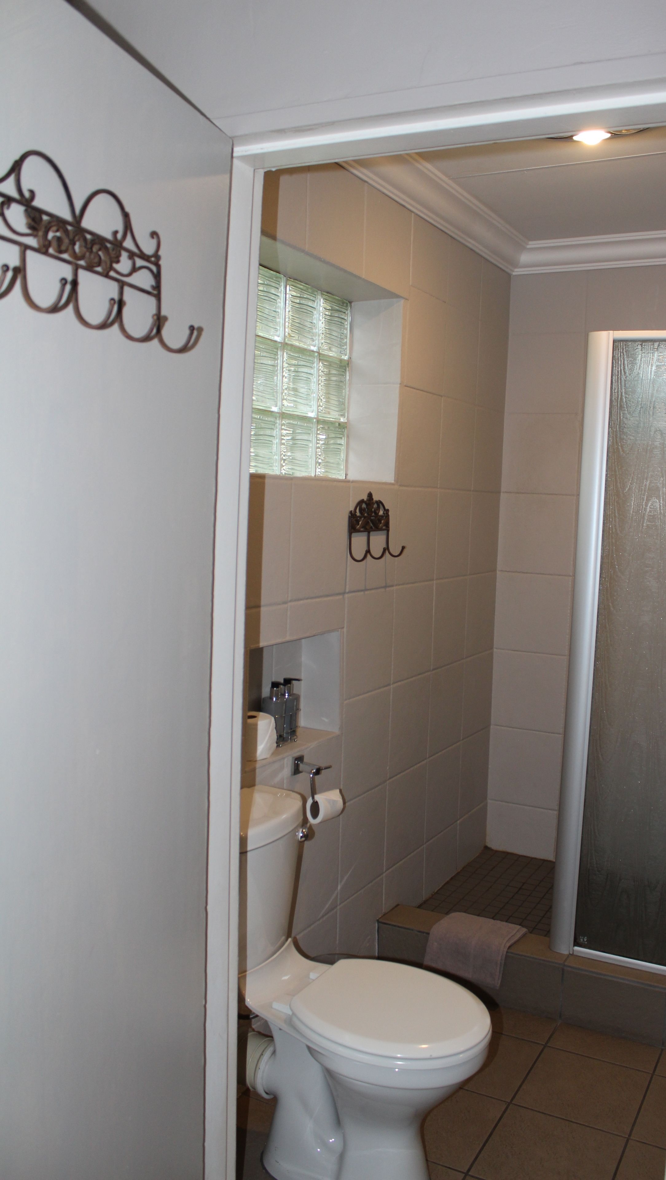 Ein Badezimmer mit Toilette, Waschbecken und Duschbereich.