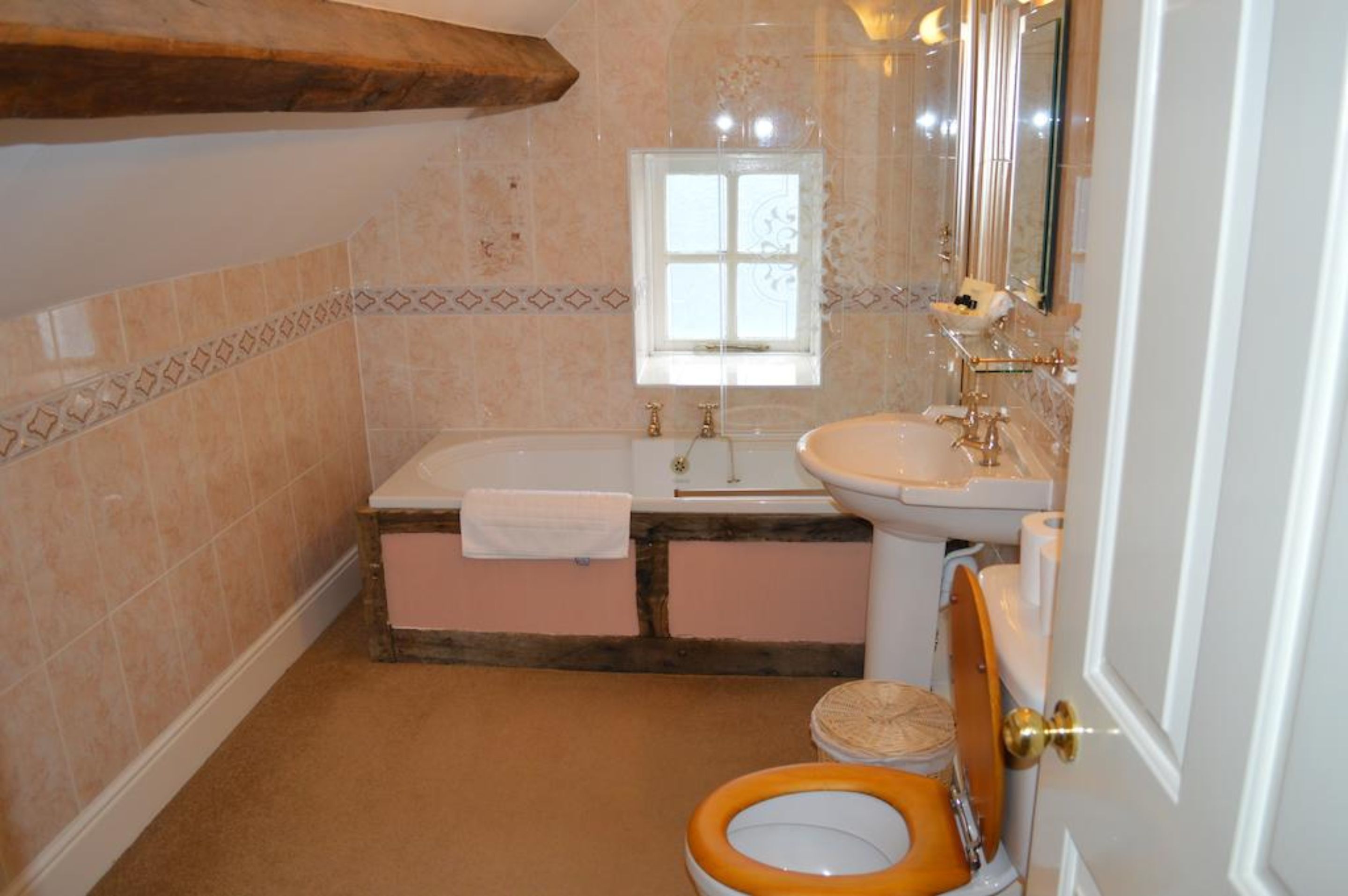 A bathroom with a bathtub, sink, and toilet.