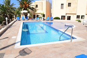 Outdoor pool, pool umbrellas, sun loungers