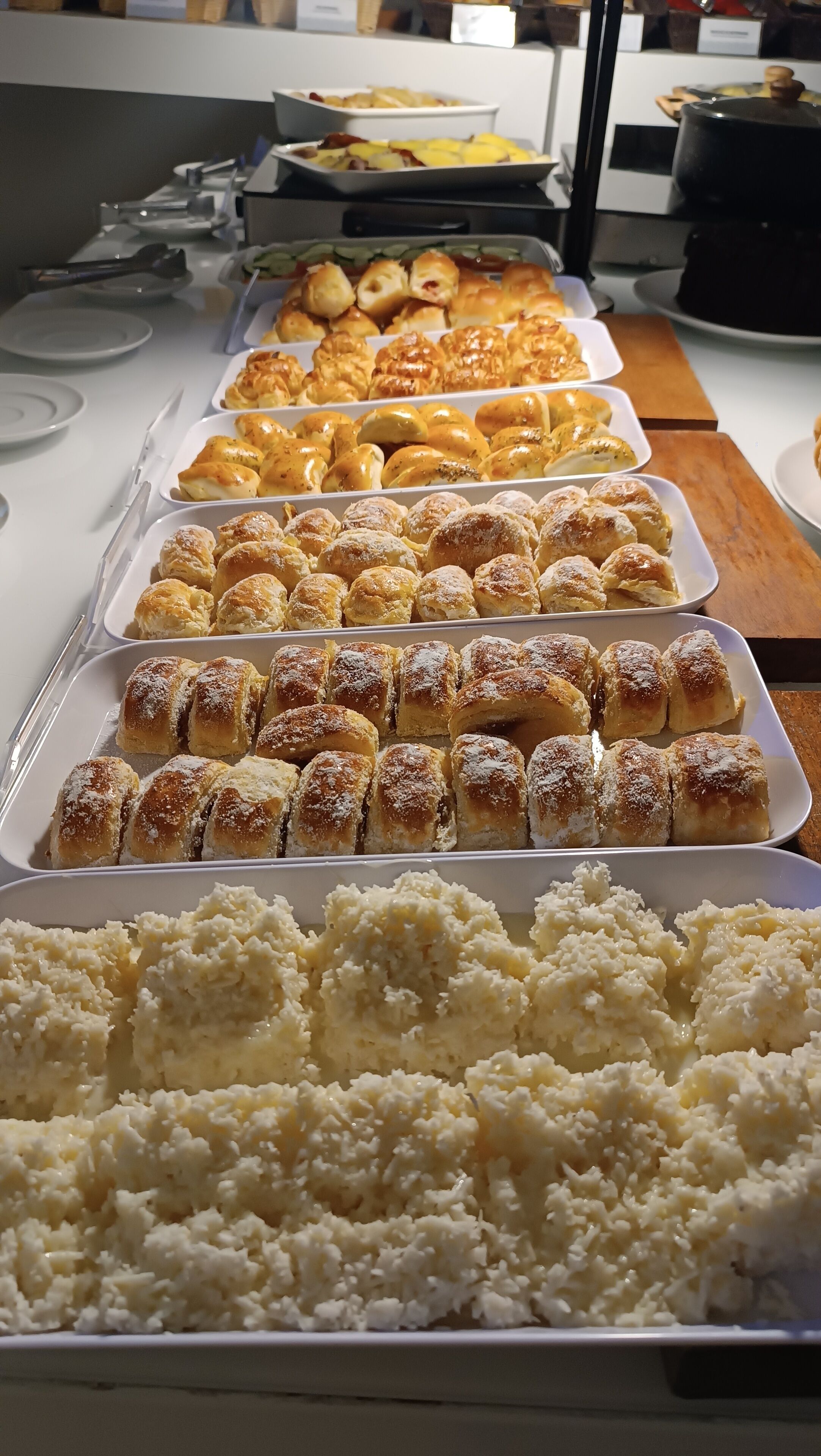 A buffet with various food items including pastries and rice dishes.