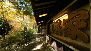 A traditional Japanese building with a stone pathway and wooden signage. - Momijiya Bekkan Kawanoiori (Kyoto)