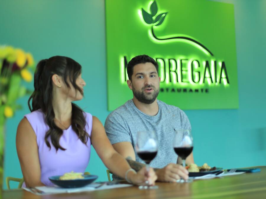 A restaurant interior with a green wall and a logo.