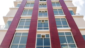 A tall building with a prominent 'AAA MANSION' sign at the bottom. - AAA Mansion (Hat Yai)
