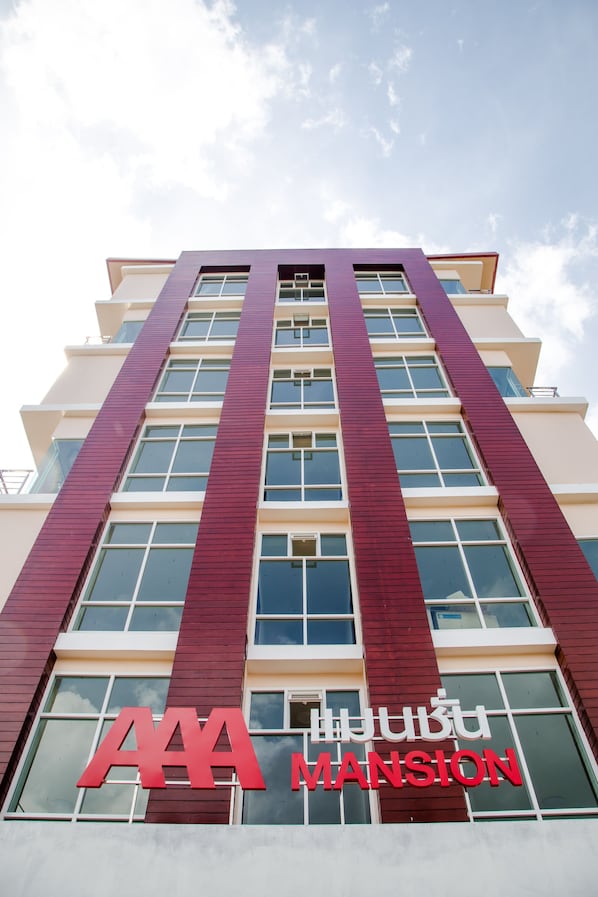 A tall building with a prominent 'AAA MANSION' sign at the bottom.