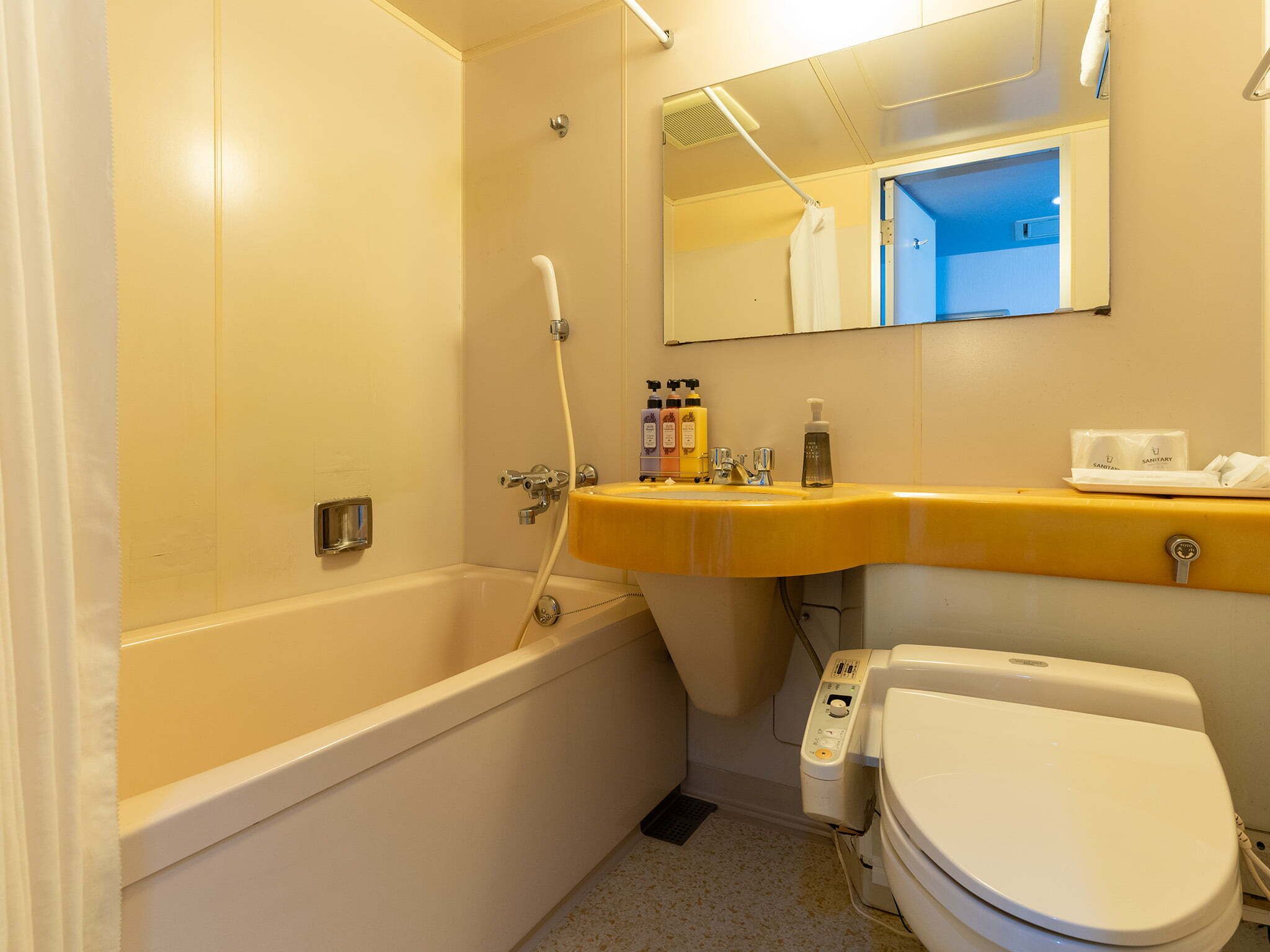 A bathroom with a bathtub, a sink, and a toilet.