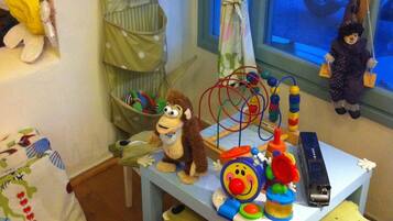 Children can play and learn in this room with a table of toys and educational items.