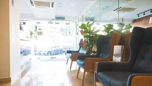 A reception area with a glass door leading outside, a plant, and a sign indicating 'KELUAR'. - i-Hotel Kuala Lumpur (Kuala Lumpur)