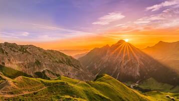 A mountainous landscape with a winding road and a valley.