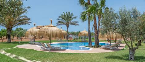 Piscine couverte, piscine extérieure, parasols de plage, chaises longues