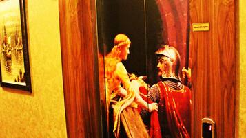 An elevator with a wooden interior and a vintage painting depicting a historical scene.