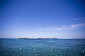 Ubicación cercana a la playa, arena blanca, tumbonas y sombrillas