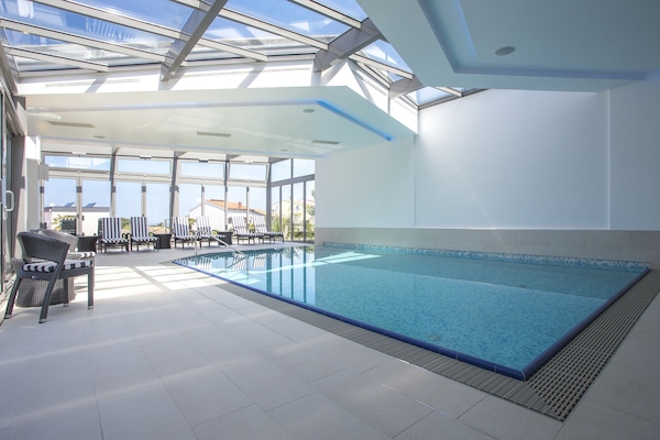 Indoor pool, open 9 AM to 9 PM, pool umbrellas, sun loungers
