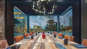 A conference room with a long wooden table, leather chairs, and a glass partition. - Royalton Blue Waters Montego Bay, An Autograph Collection All Inclusive Resort (Falmouth)