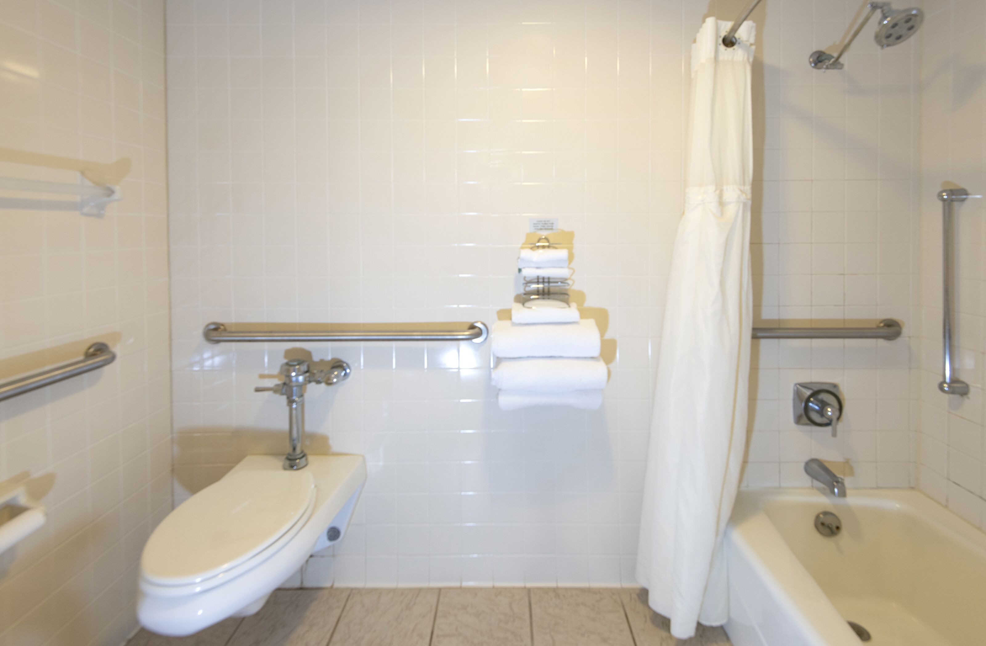 A bathroom with a toilet, a bathtub, and a shower.