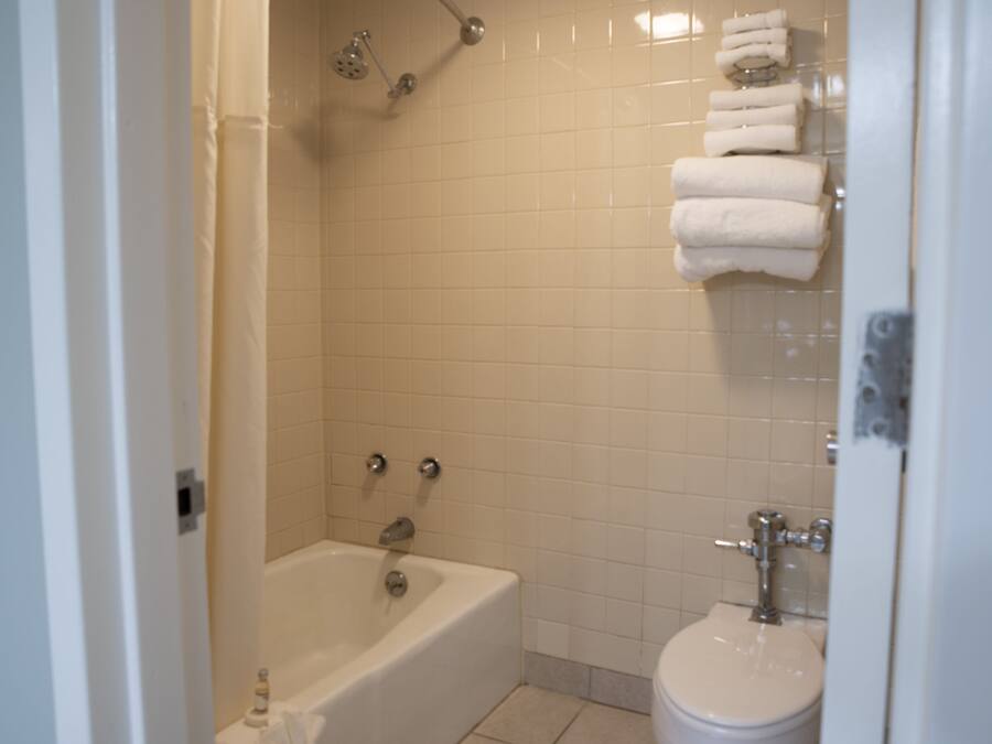 A bathroom with a bathtub, a toilet, and a shower.