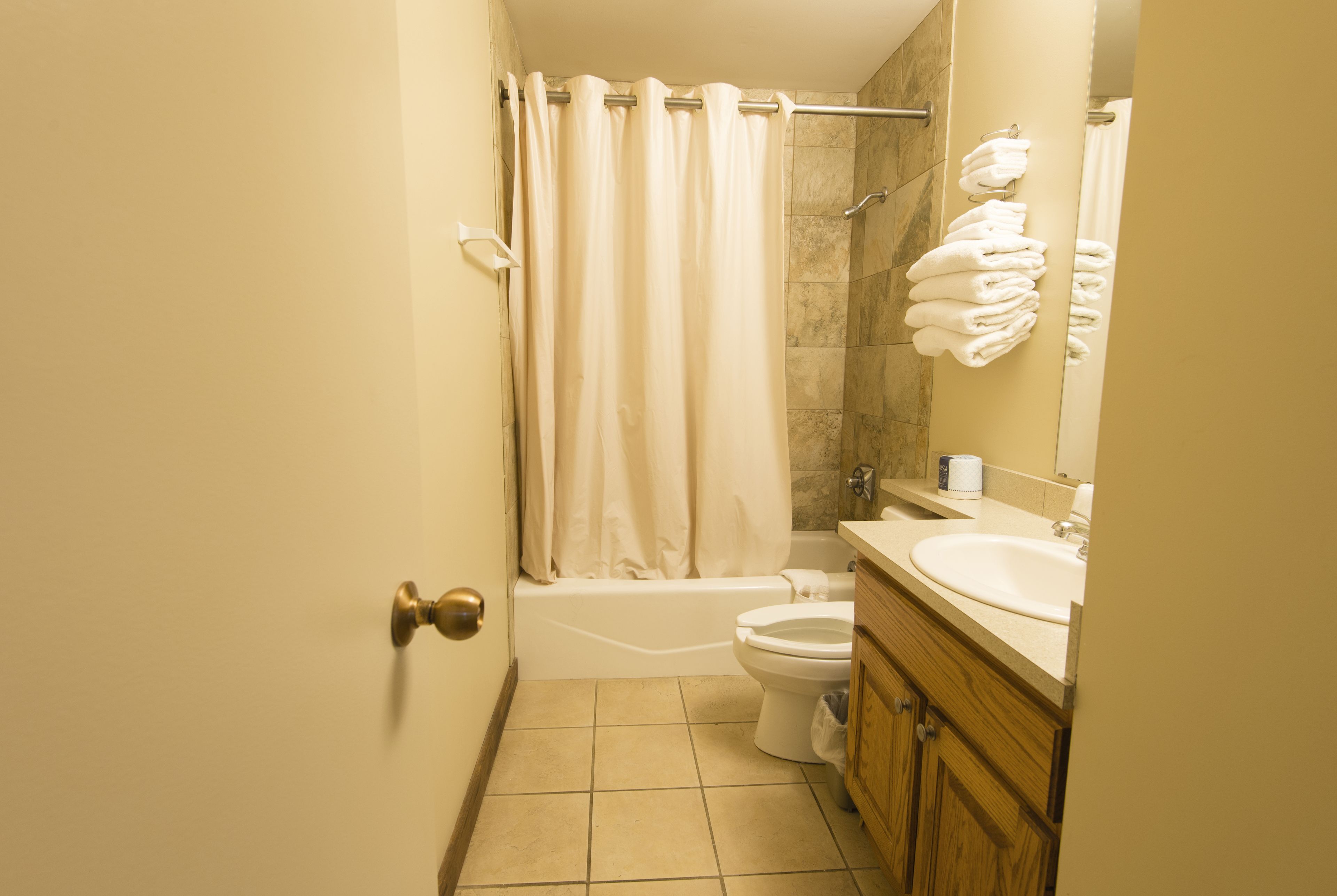 A bathroom with a bathtub, toilet, and sink.
