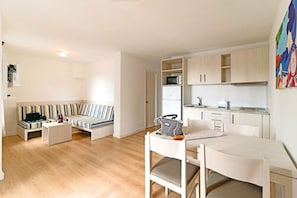 A modern apartment with a living room, a dining area, and a kitchen.