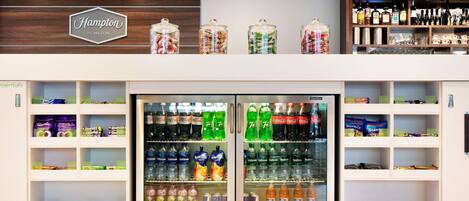 A hotel minibar with a variety of beverages and snacks.