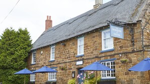 A stone building with a sign reading "The Marquess of Exeter." - The Marquess Of Exeter (Oakham)
