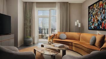 A modern living room with a sofa, coffee table, and television.