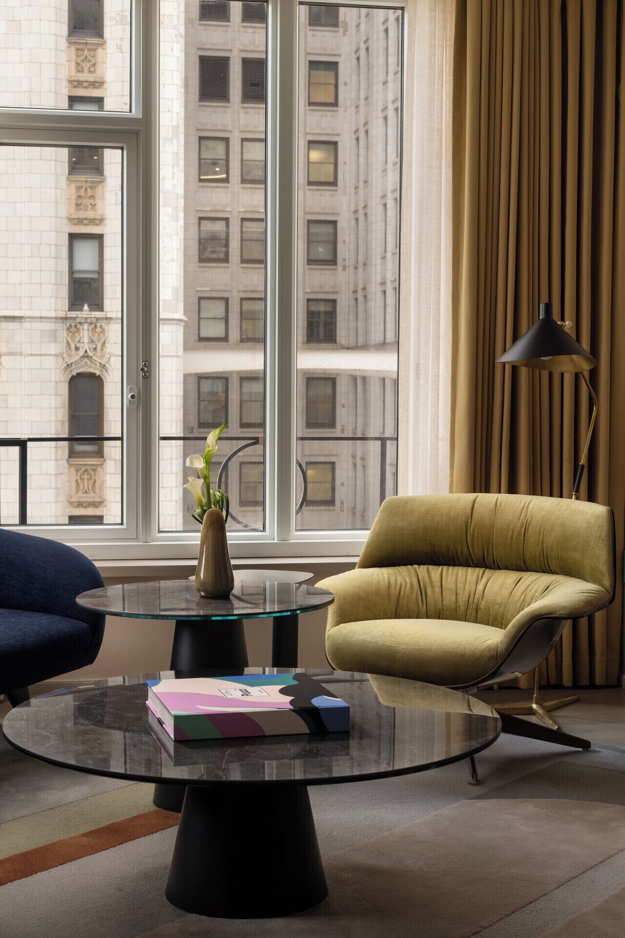 A modern living room with a sofa, a coffee table, and a lamp.