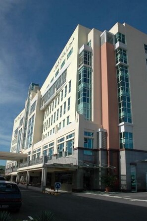 A multi-story hotel with a modern architectural design, featuring a prominent entrance with a covered area and a visible parking lot. - Kiulap Plaza Hotel (Bandar Seri Begawan)