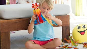 A child sitting on the floor assembling a puzzle with colorful pieces.