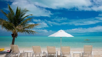 On the beach, white sand, beach umbrellas, beach towels