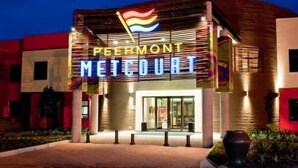 A hotel entrance with a neon sign reading "PEIRMONT METCOURT". - Peermont Metcourt at Umfolozi (Empangeni)