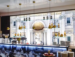 A bar area with a classical architectural backdrop, a large globe, and various bottles. - ibis Styles Gniezno Stare Miasto (Gniezno)