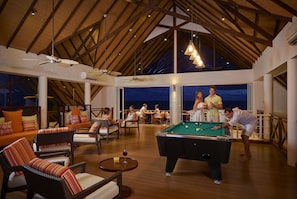 A spacious indoor area with a pool table, comfortable seating, and large windows offering views of the outside. - Mercure Maldives Kooddoo Adult-Only Resort (Kooddoo)