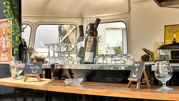 A bar area with bottles, glasses, and a chalkboard menu.