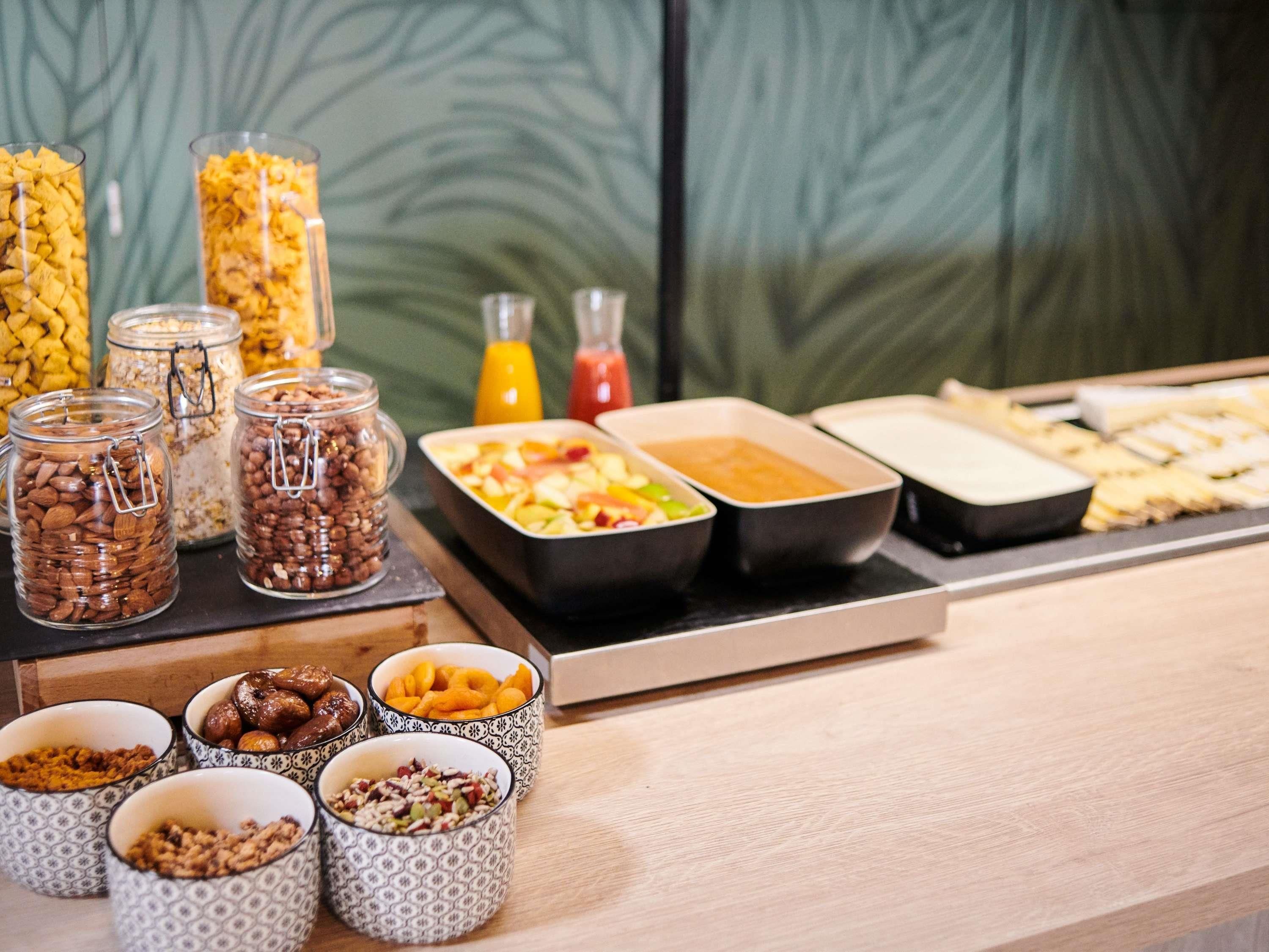 A buffet with various food items and condiments.