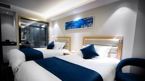 A hotel room with two beds, each with a headboard, a nightstand, and a lamp. - LYZ Business Hotel (Lima)