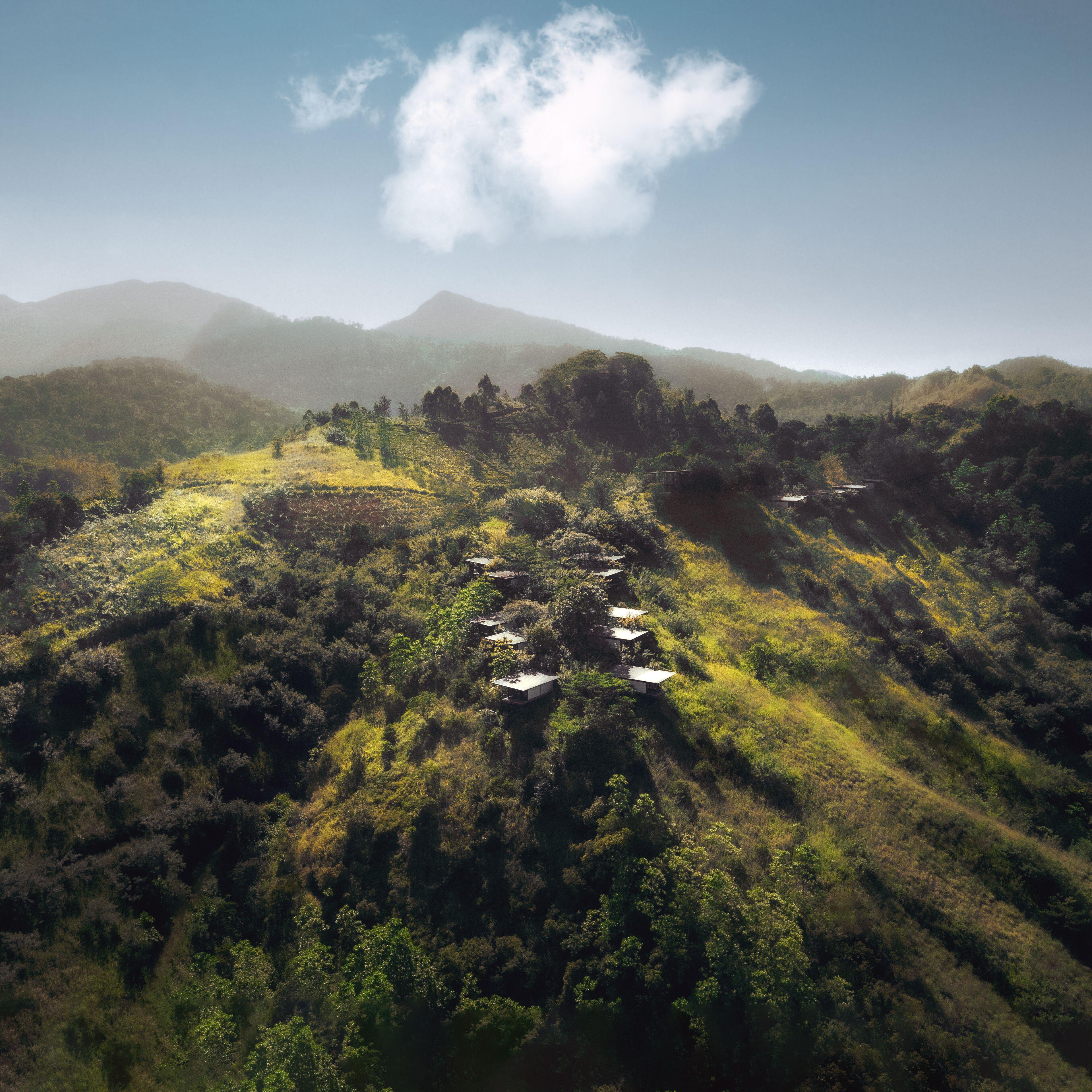Un paysage montagneux parsemé de quelques petits bâtiments nichés au milieu des arbres.