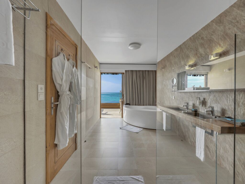 lagoon suite with pool​ | bathroom | shower, rainfall showerhead, eco-friendly toiletries, hair dryer