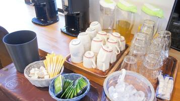 A buffet setup with various food items and drink dispensers.