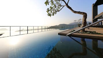 Outdoor pool, open 7 AM to 10 PM, sun loungers, lifeguards on site