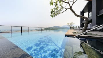 Outdoor pool, open 7 AM to 10 PM, pool loungers, lifeguards on site