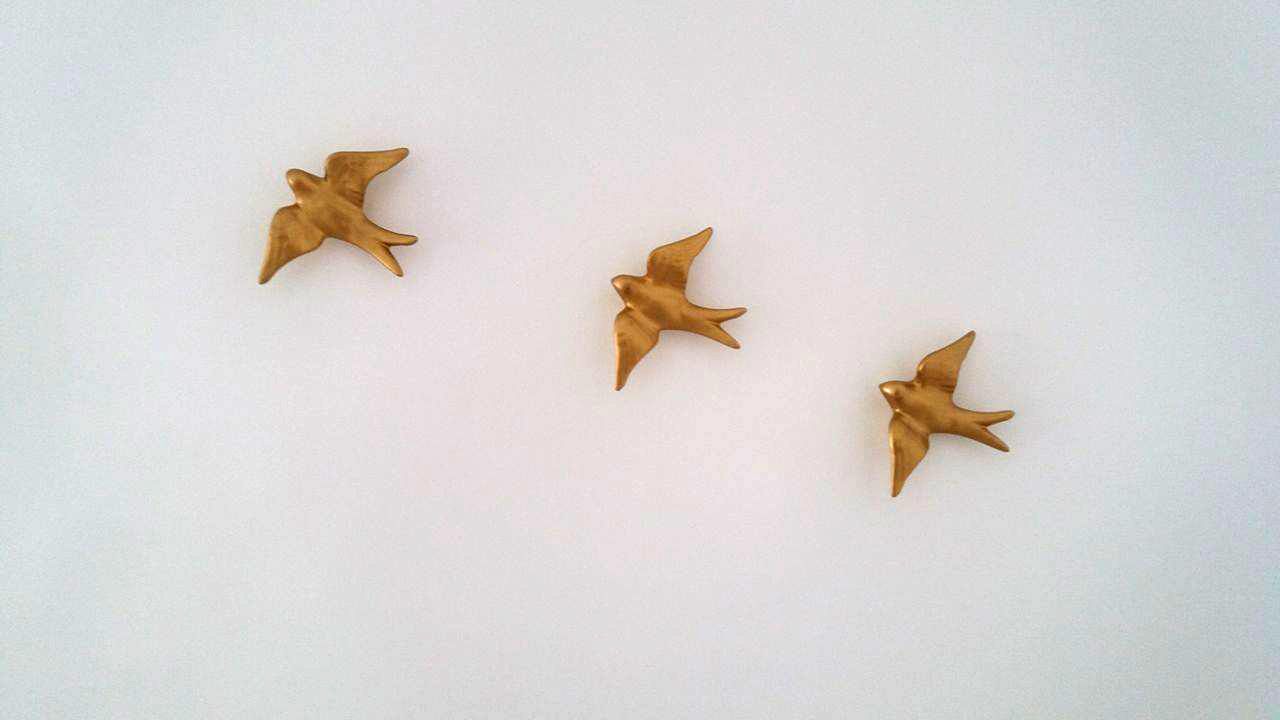 Three golden star-shaped objects on a plain white background.