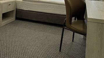 Relax in a spacious room with a large bed, flat-screen TV, and comfortable seating area.