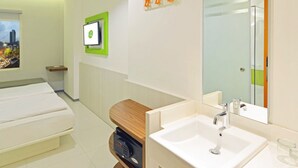 A modern bathroom with a large mirror, a double sink, and a wooden vanity. - POP! Hotel Pasar Baru Jakarta (Jakarta)