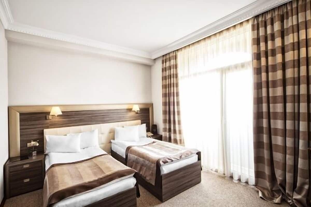 Standard Triple Room | Minibar, in-room safe, desk, soundproofing
