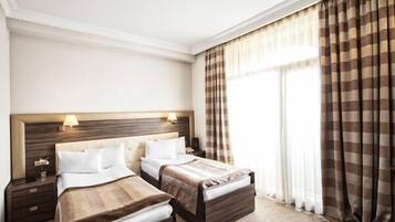 Standard Triple Room | Minibar, in-room safe, desk, soundproofing