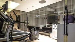 A modern gym with treadmills, elliptical machines, and exercise equipment. - Cruise Hotel (Tbilisi)