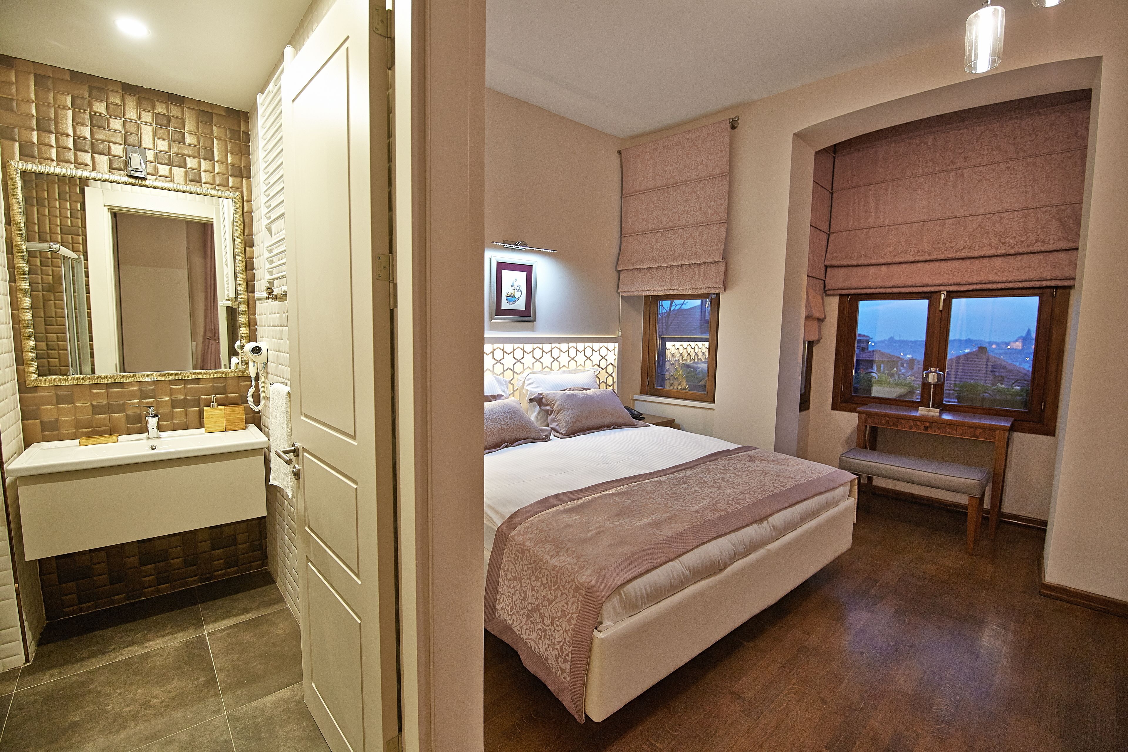 A bedroom with a bed, bedside table, and a window with a view.